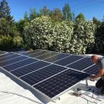 Solar panels getting installed by technician