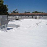 Commercial foam roof with vents near apartments