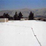 Commercial polyurethane foam roof with hills in background