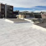Commercial dura foam roof next to neighboring buildings
