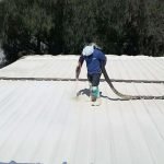 Foam spray roofing application by Dura-Foam worker
