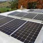 Solar panels on roof overlooking hills